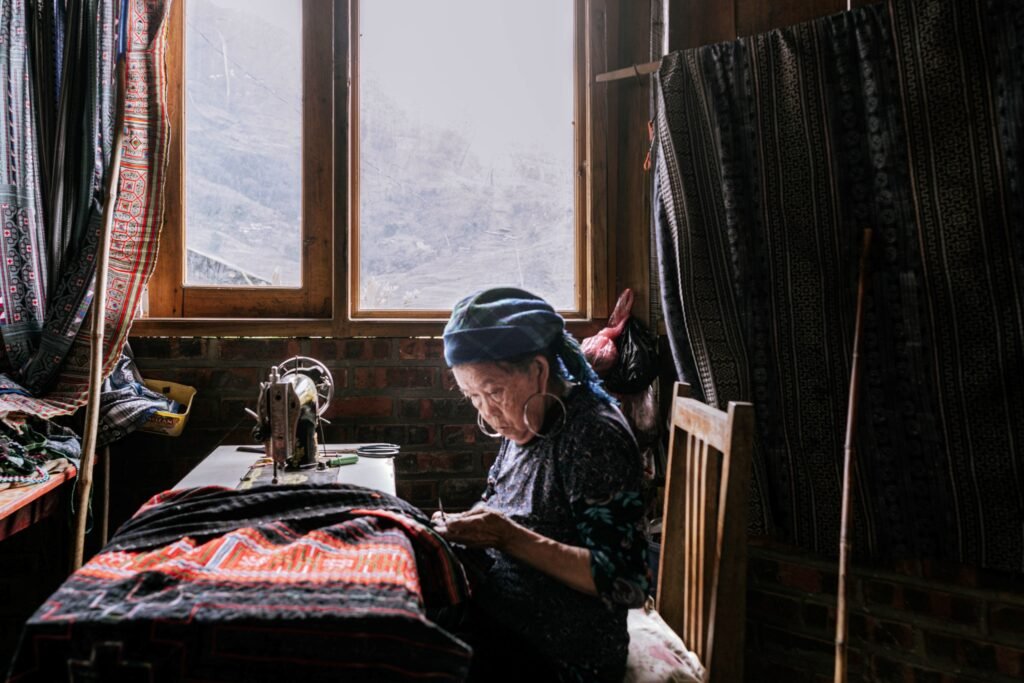 Seamstress in Sapa, 2025. by Pierandrea Fischetti, exhibited at Aurea Photo Gallery.