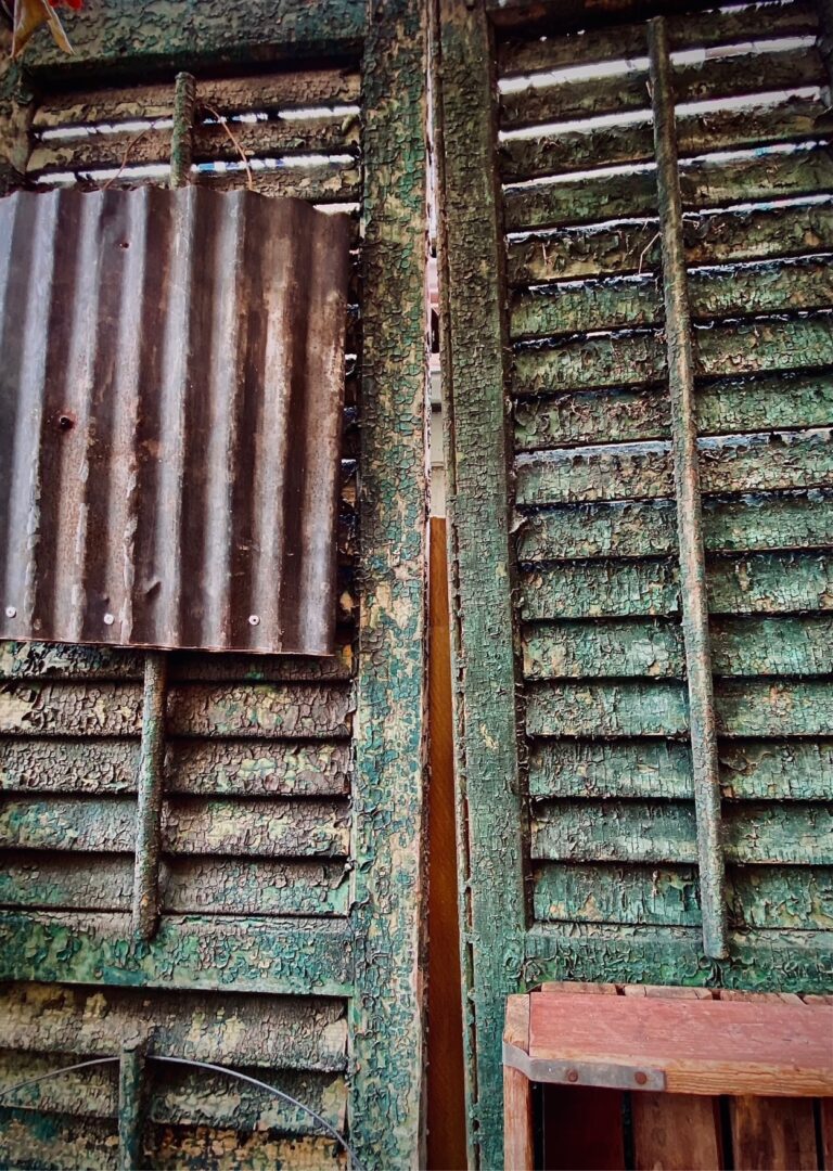 Original Shutters that survived Hurricane Katrina, 2022. by Michael Watz, exhibited at Aurea Photo Gallery.